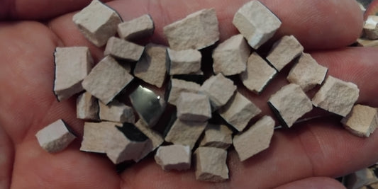 a handful of ceramic tile tesserae cut up ready for mosaic