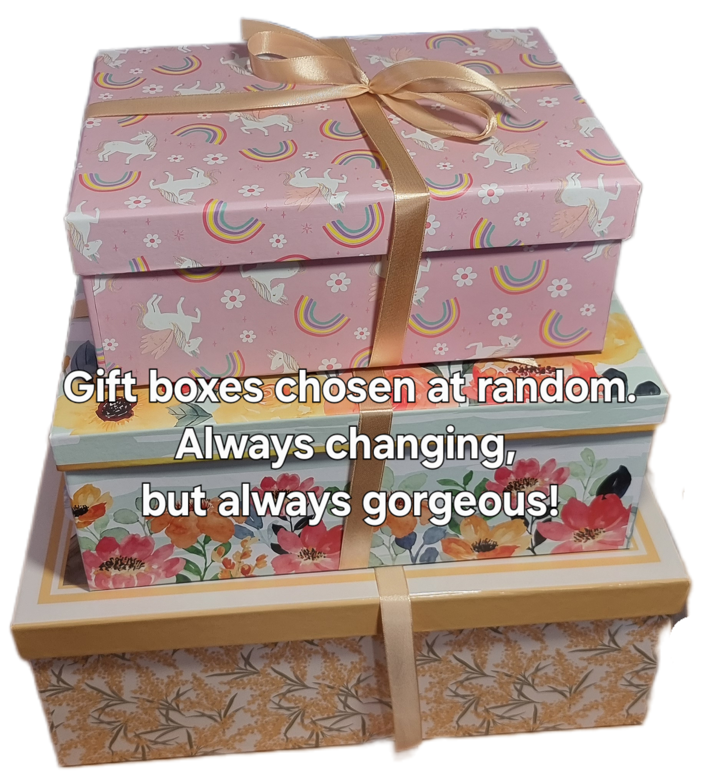 A variety of giftboxes stacked on top of one another wrapped in gold ribbon for sale