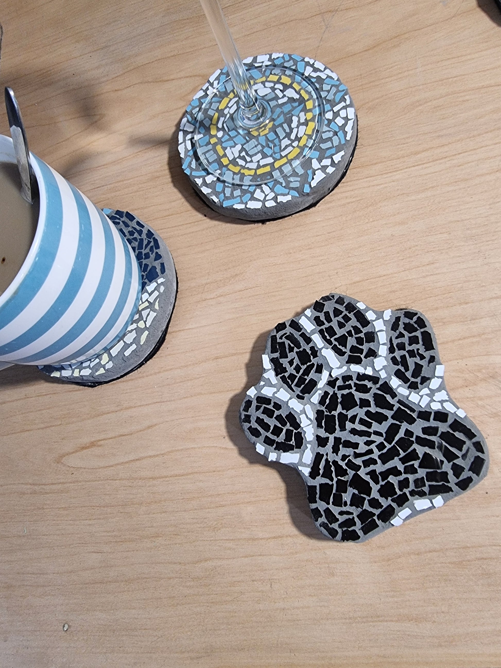 Paw print coaster with 2 others behind with cups on them for sale