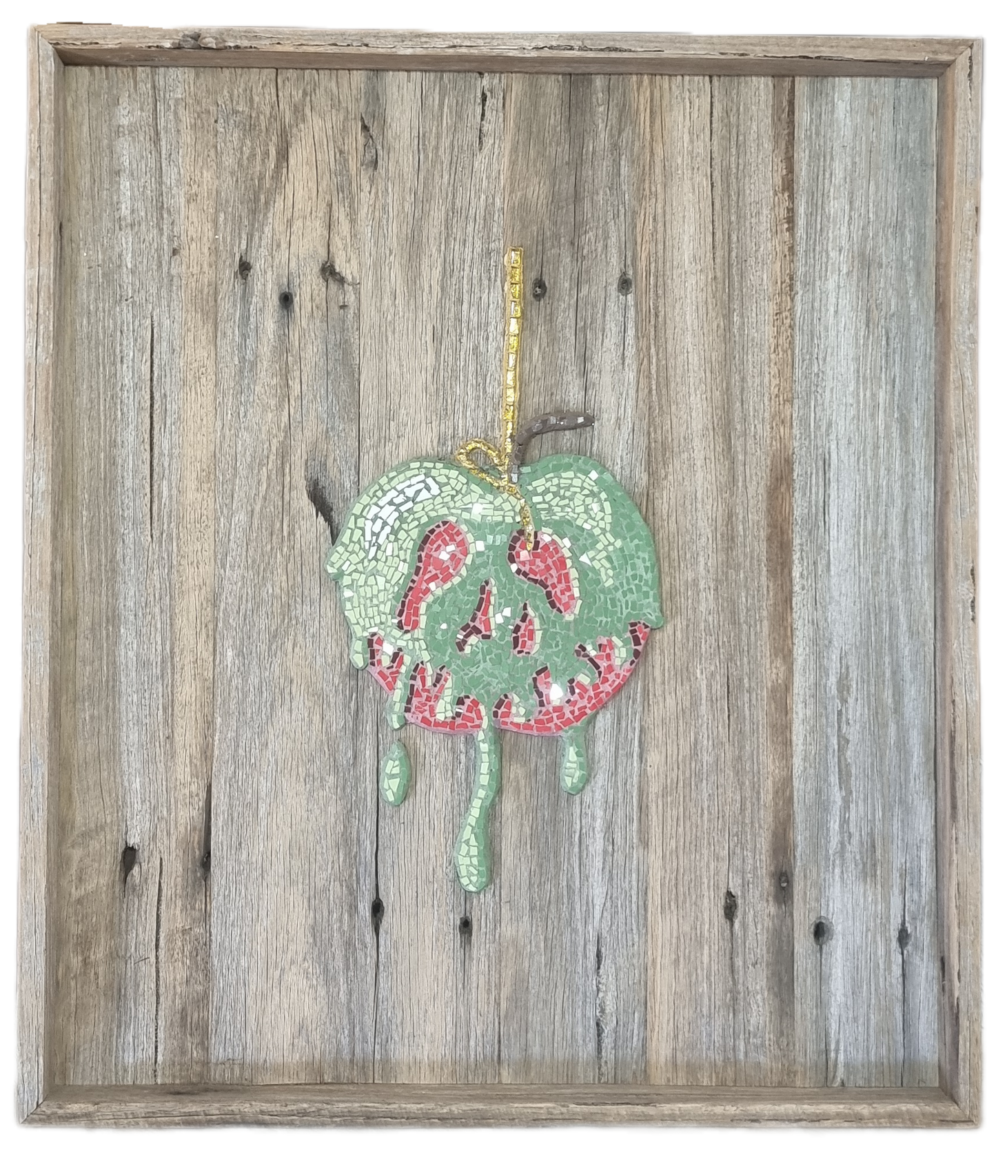 Poisoned Apple mosaic mounted in a shadow box frame, photographed with no background. The glass tiles catch the light, creating a sparkling effect that highlights the rich reds and dark accents of the design.
