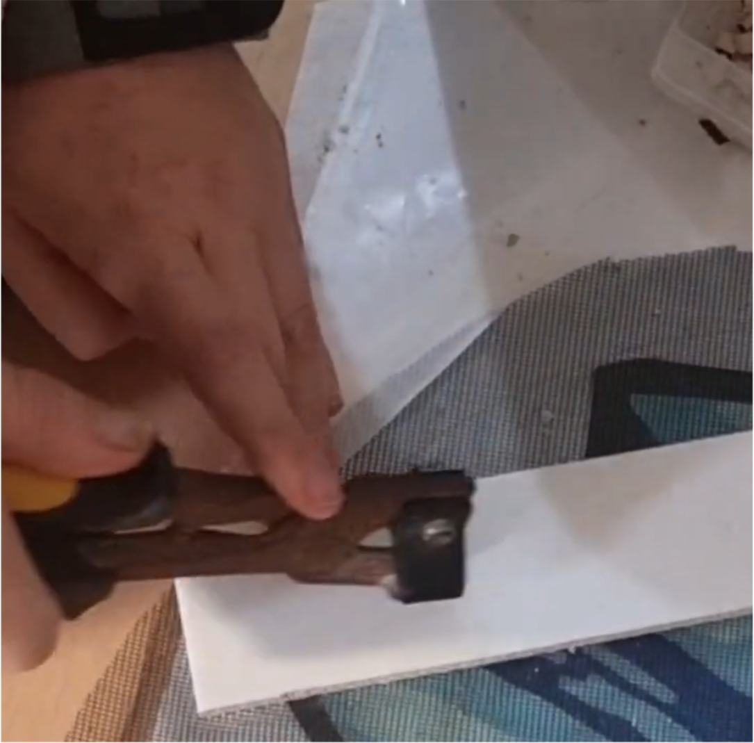 Load video: Close-up ASMR video of white tiles being precisely cut for the custom daisy mosaic, capturing the crisp snapping sounds, filmed on 1 August 2025.