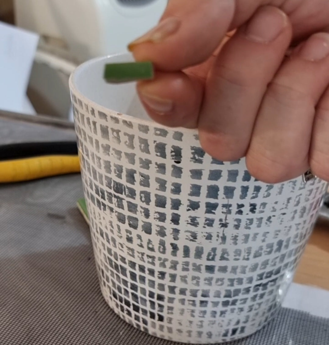 Load video: Video tutorial demonstrating eco-conscious shard tiling, where recycled or broken tiles are cut and shaped for mosaic use. The artist explains techniques while cutting irregular pieces, promoting sustainable practices in mosaic art.