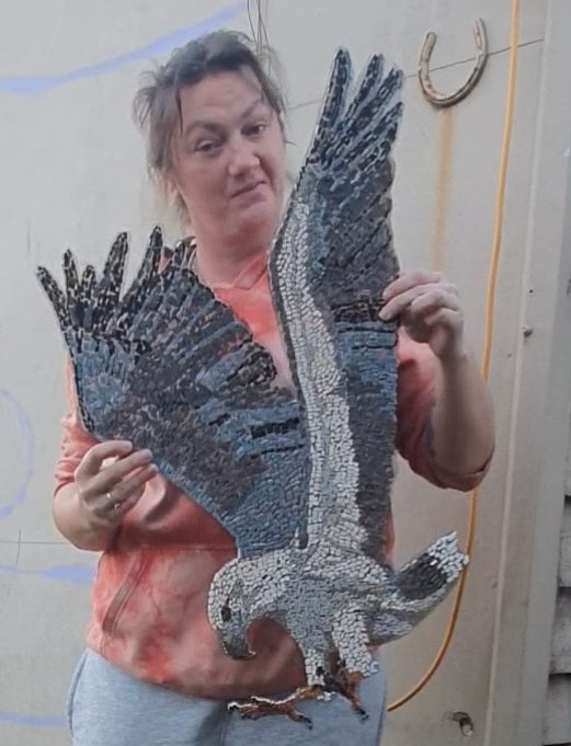 Merrin holding White-bellied Sea Eagle mosaic for size comparison. Mosaics handmade in Sebastopol, Victoria 