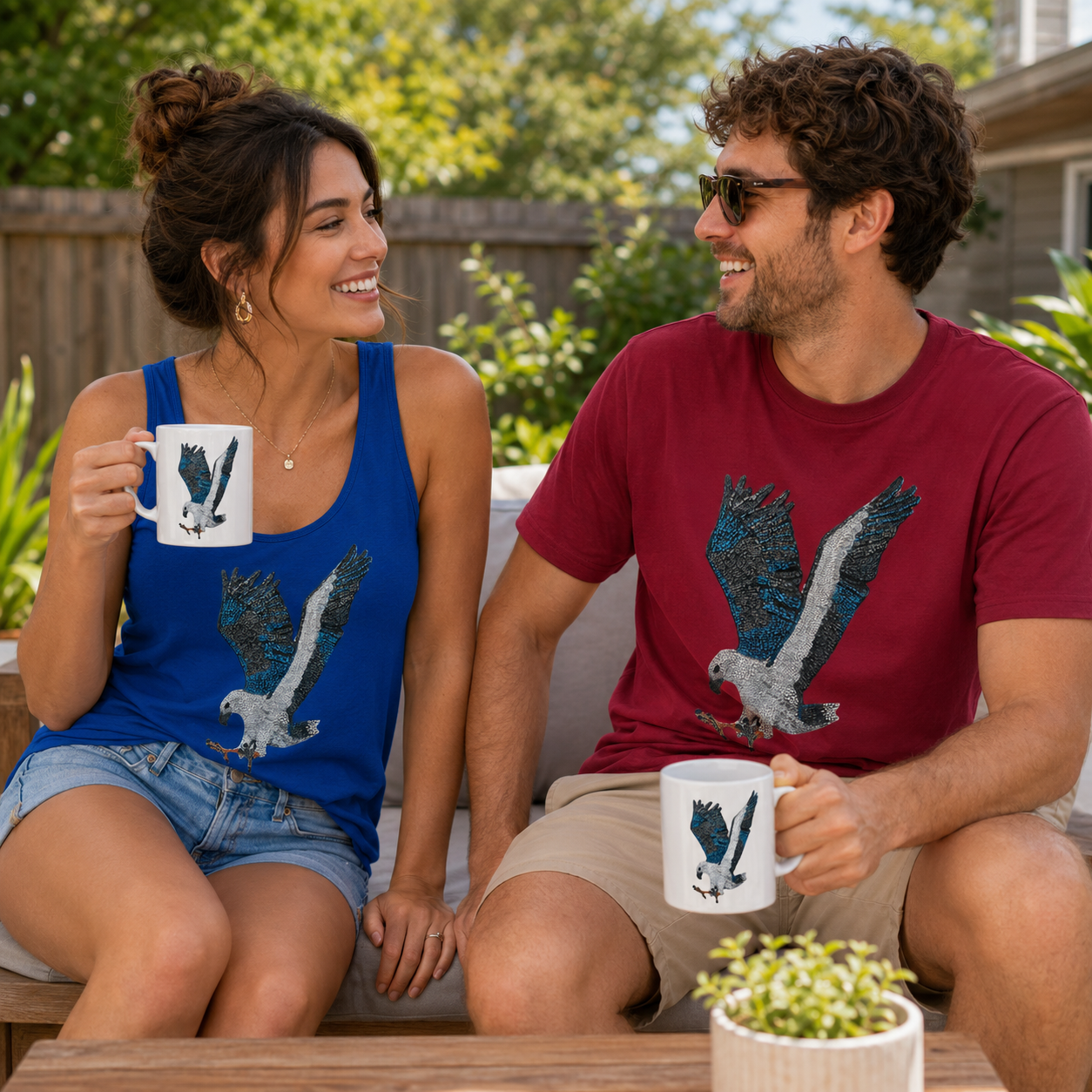 willoe the white-bellied sea eagle mosaic displayed out doors on 15 oz ceralic mugs a casual blue willow tank top and a dark red willow printed t shirt, enjoying their outdoor time together