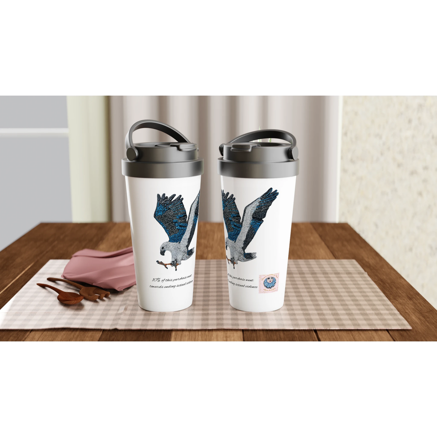 Willow the white-bellied sea eagle mosaic is displayed on 2 Travel mugs on a dining table setup merrins art