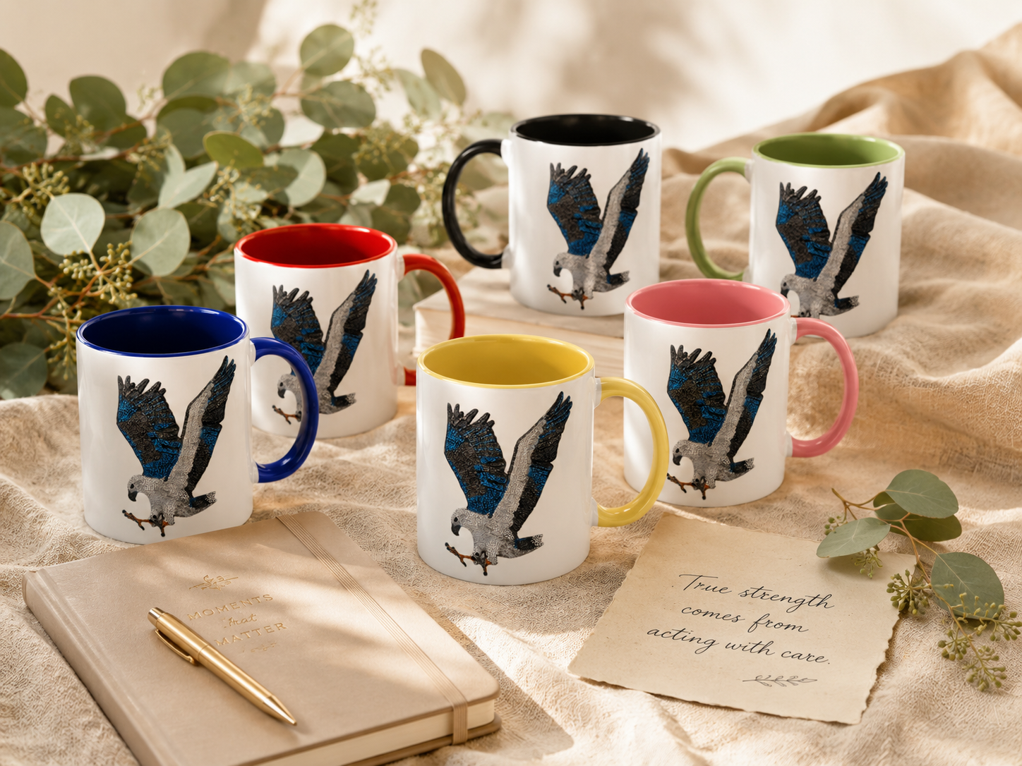 Willow White-bellied Sea Eagle mosaic mugs styled with a journal, eucalyptus, soft linen and warm natural light, with a handwritten note reading True strength comes from acting with care.