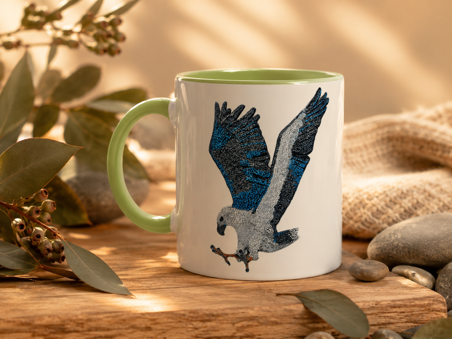 Willow White-bellied Sea Eagle green handle mug styled with native Australian greenery, smooth river stones, timber textures and golden natural light for a calm nature-inspired lifestyle scene.