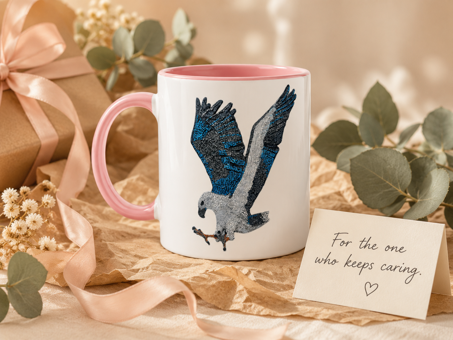 Willow White-bellied Sea Eagle pink ceramic mug styled as a thoughtful gift with recycled paper, soft ribbon, eucalyptus and a card reading For the one who keeps caring.