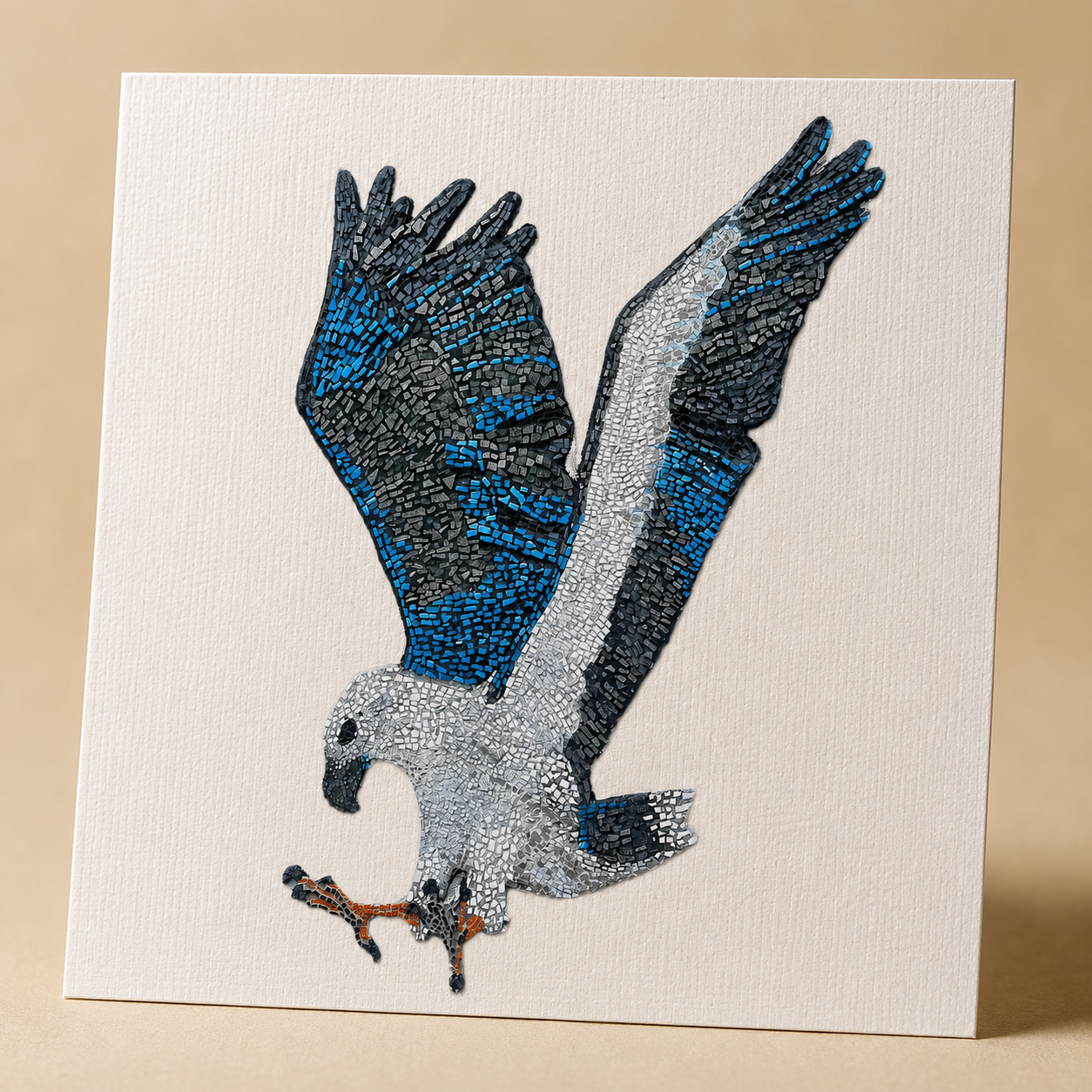 Close-up detail of the Willow White-bellied Sea Eagle mosaic postcard on linen-textured matte cardstock, showing crisp print quality, feather mosaic detail, blue and grey tile textures, and soft side lighting that highlights the premium paper finish.