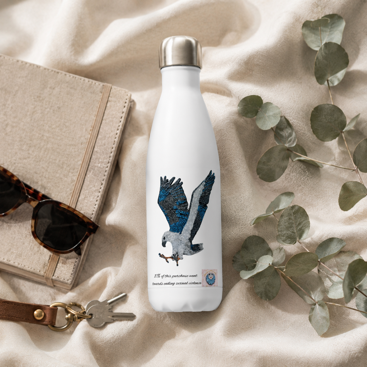 Willow White-bellied Sea Eagle insulated stainless steel water bottle styled with a journal, keys, sunglasses and eucalyptus for an everyday grab-and-go lifestyle image.