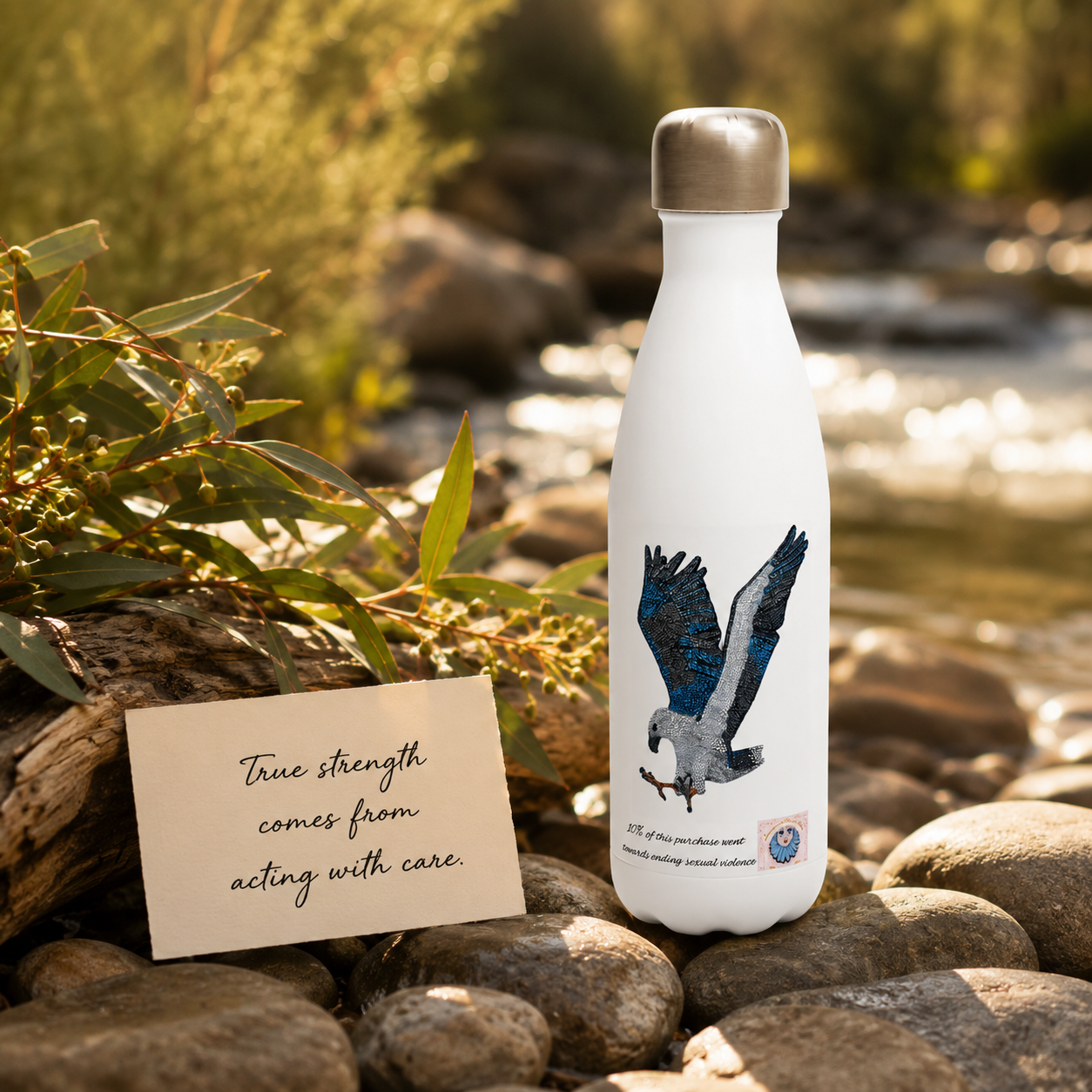 Willow White-bellied Sea Eagle mosaic water bottle beside Australian greenery, river stones and a handwritten quote card, styled as a nature-inspired wildlife art gift.