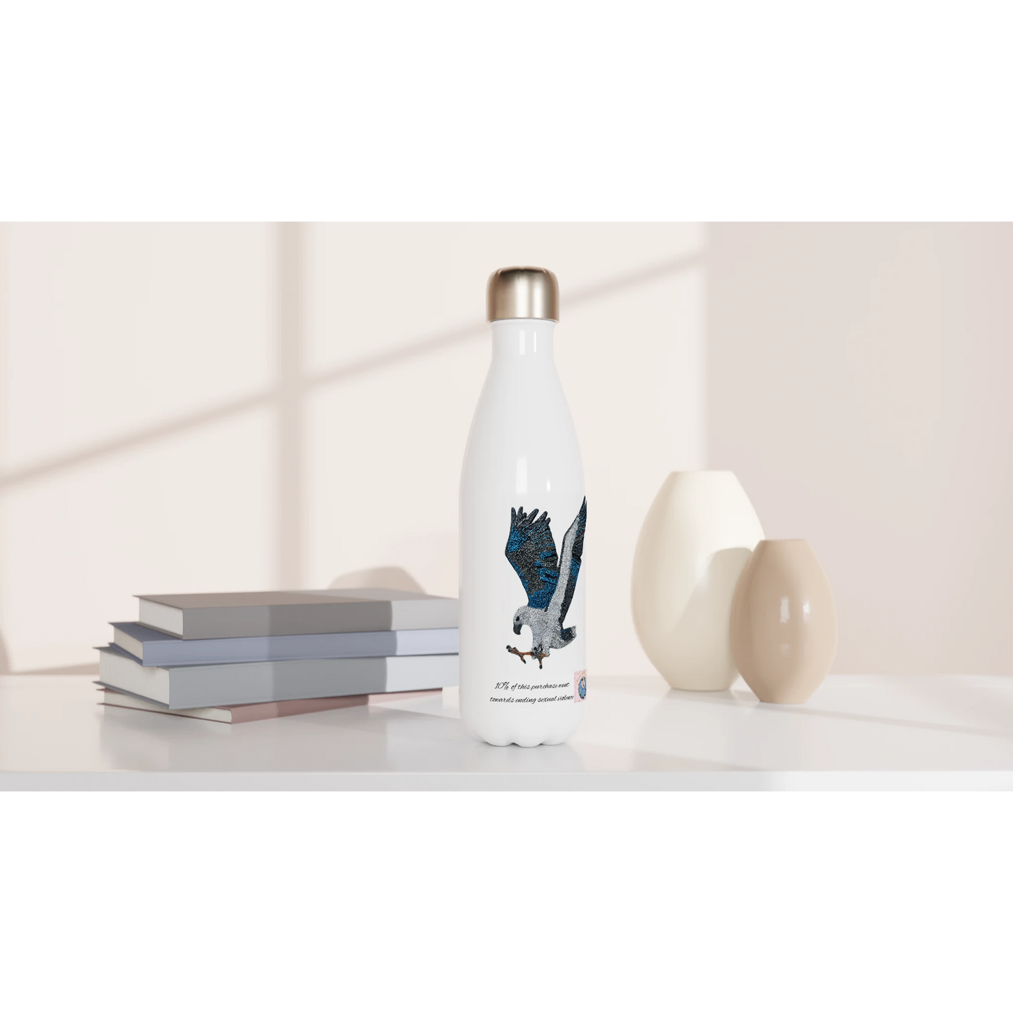Willow White-bellied Sea Eagle stainless steel water bottle styled on shelf with books and vases